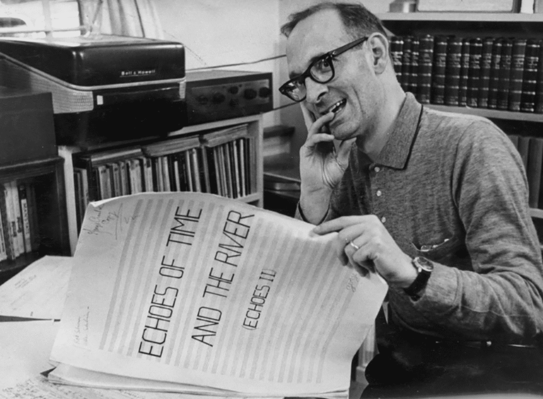 George Crumb in black and white, reviewing a hand written score.